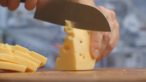 Cut-yellow-holey-cheese-on-a-wooden-board-closeup.-shred.